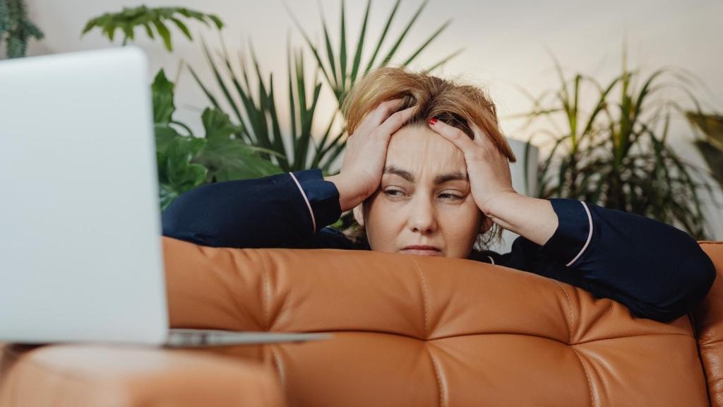 upset woman standing over the couch