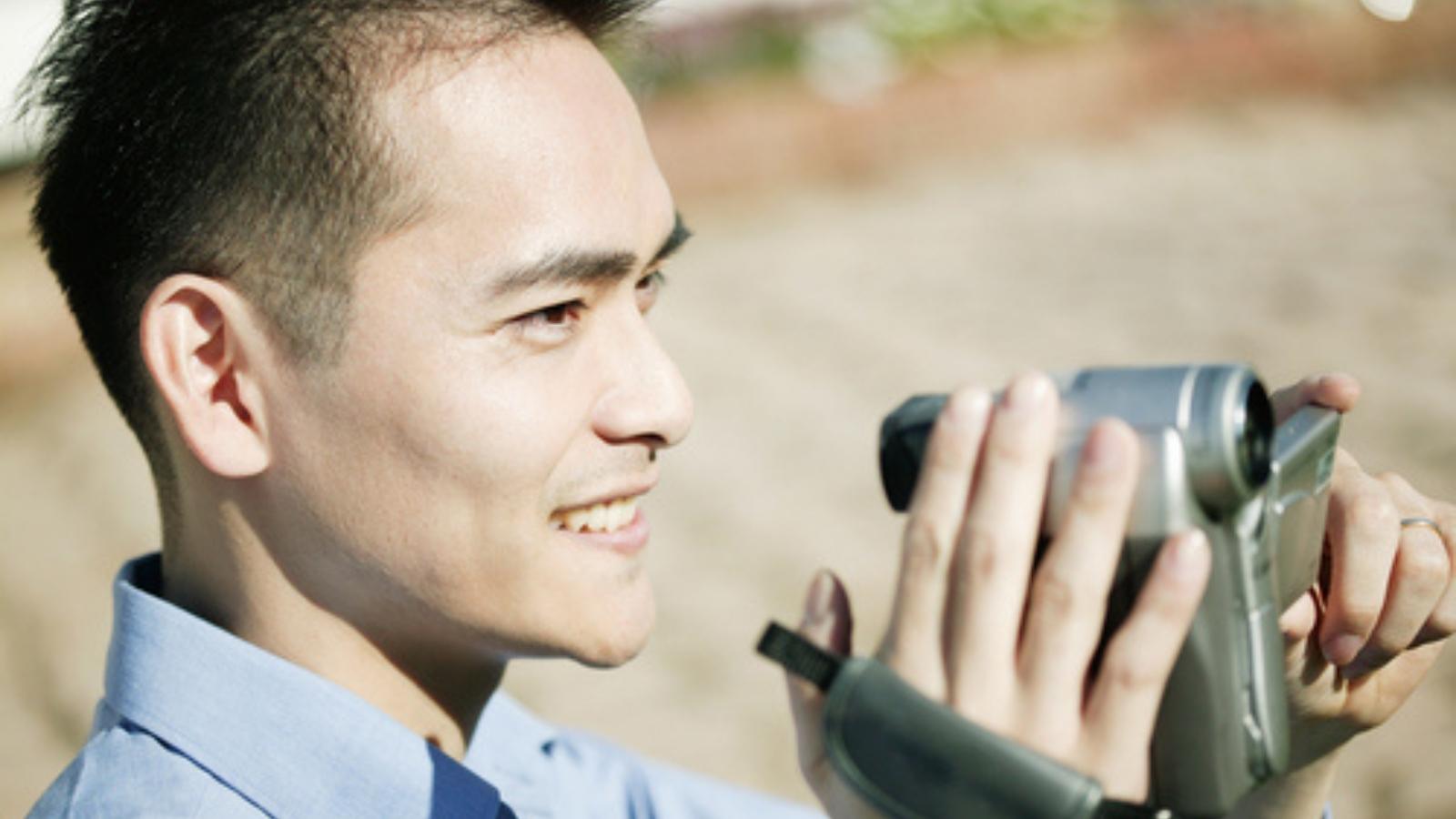 Man Constantly Films His Neighbors Leaving Their Apartment, but Police Say They Can’t Stop Him Man with camcorder.
