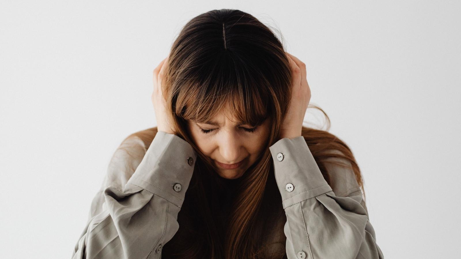 woman covering ears from loud sound