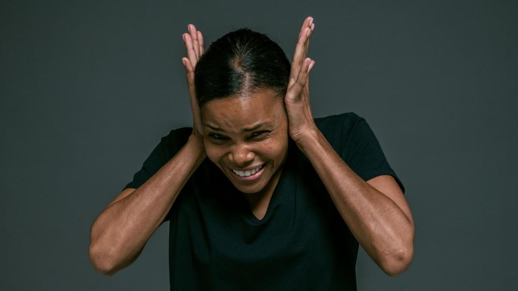 woman covering her ears from a loud sound