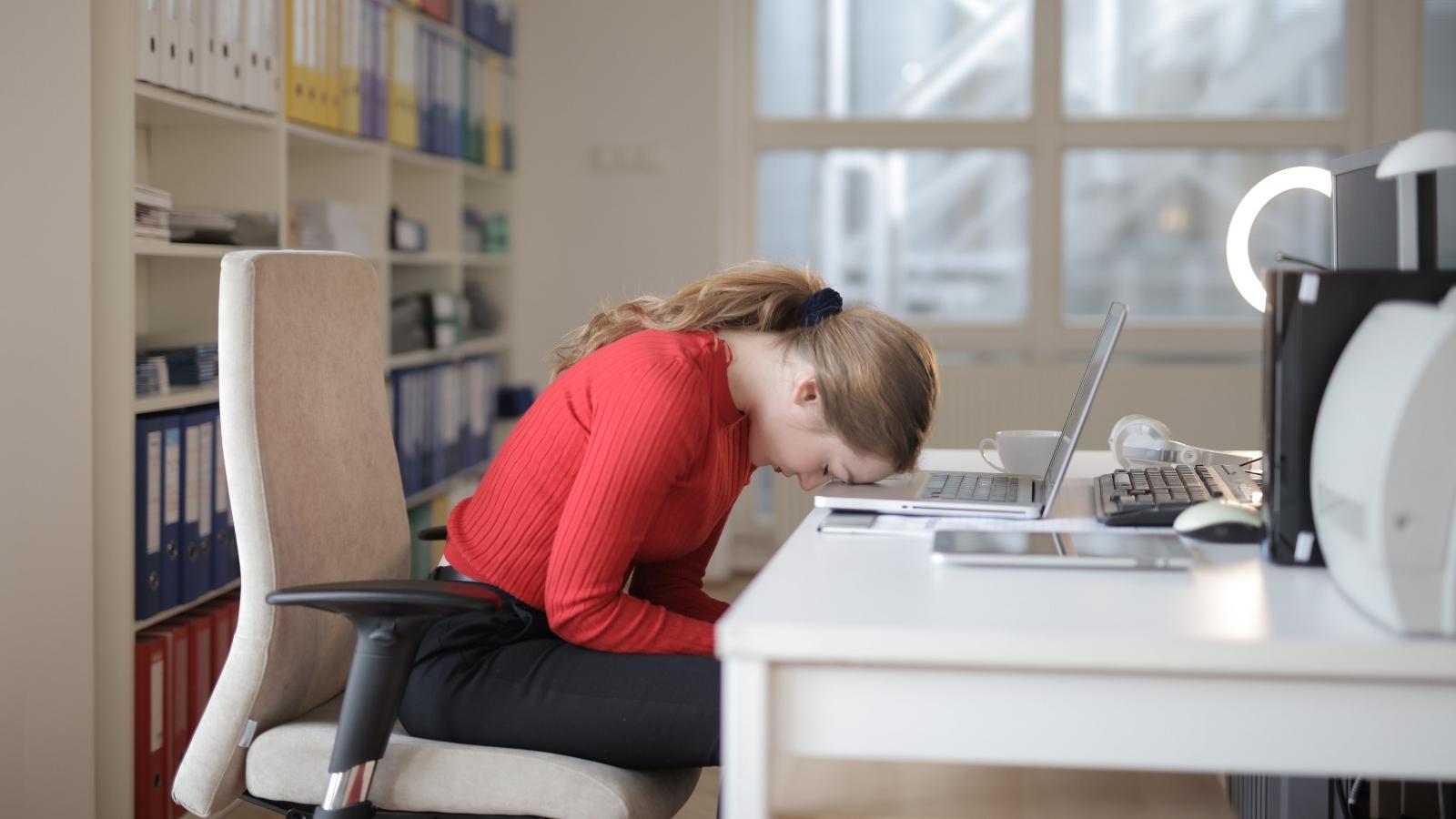 woman face down at her desk