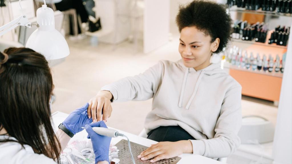 woman getting her nails done at salon
