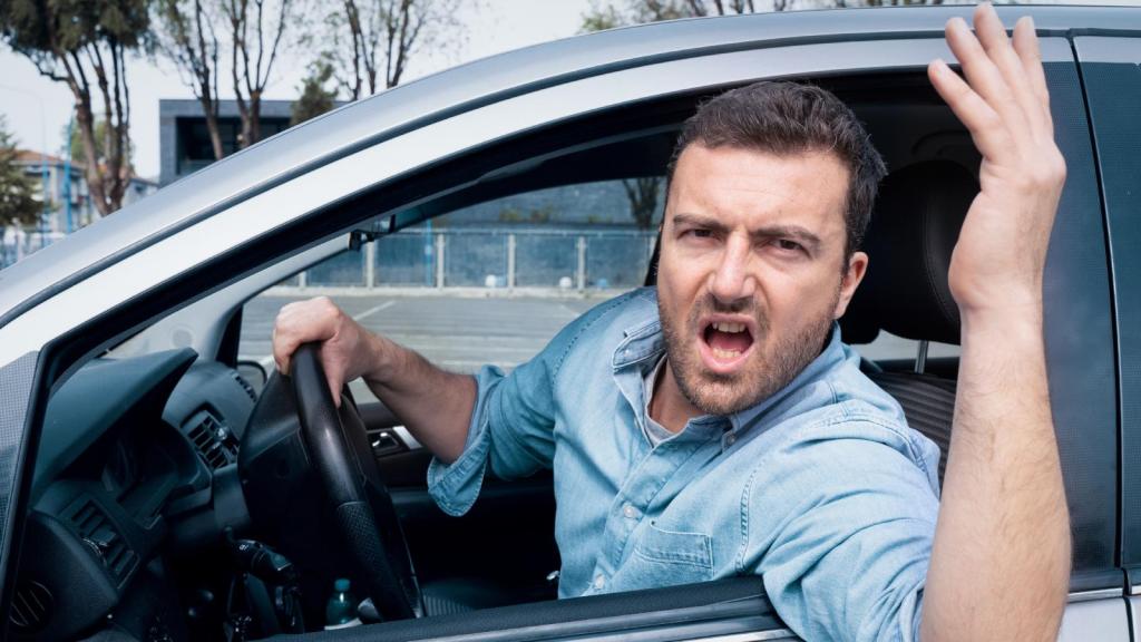 man yelling in his car