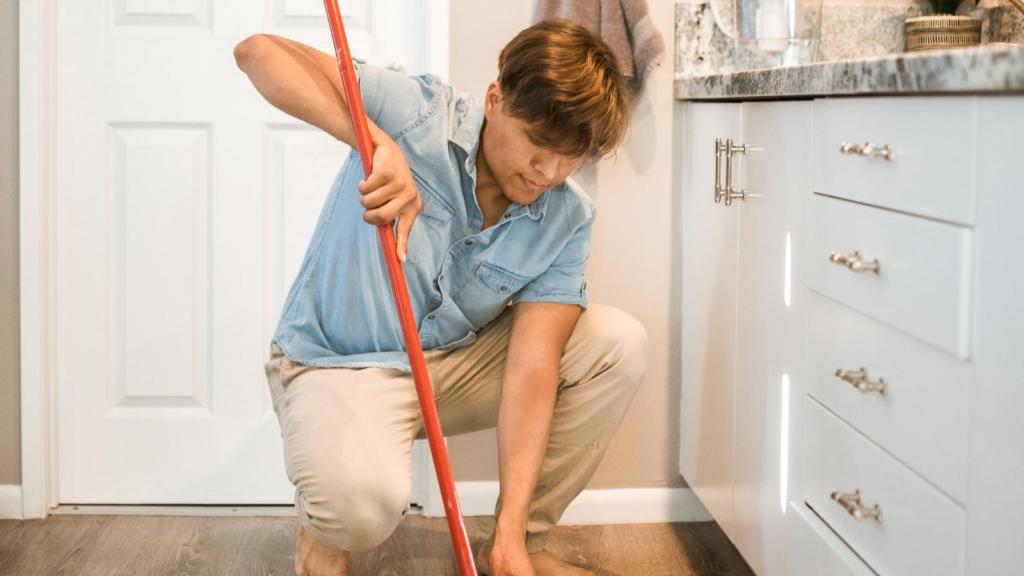 young man doing house chores