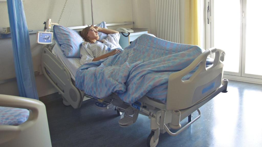 young woman sitting in hospital bed