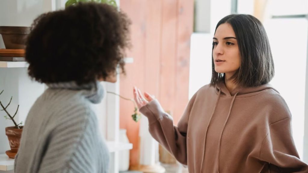 2 women having serious conversation indoors