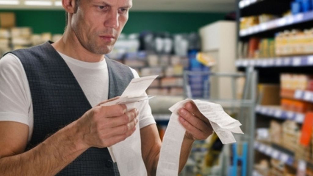 Man looking at receipts.
