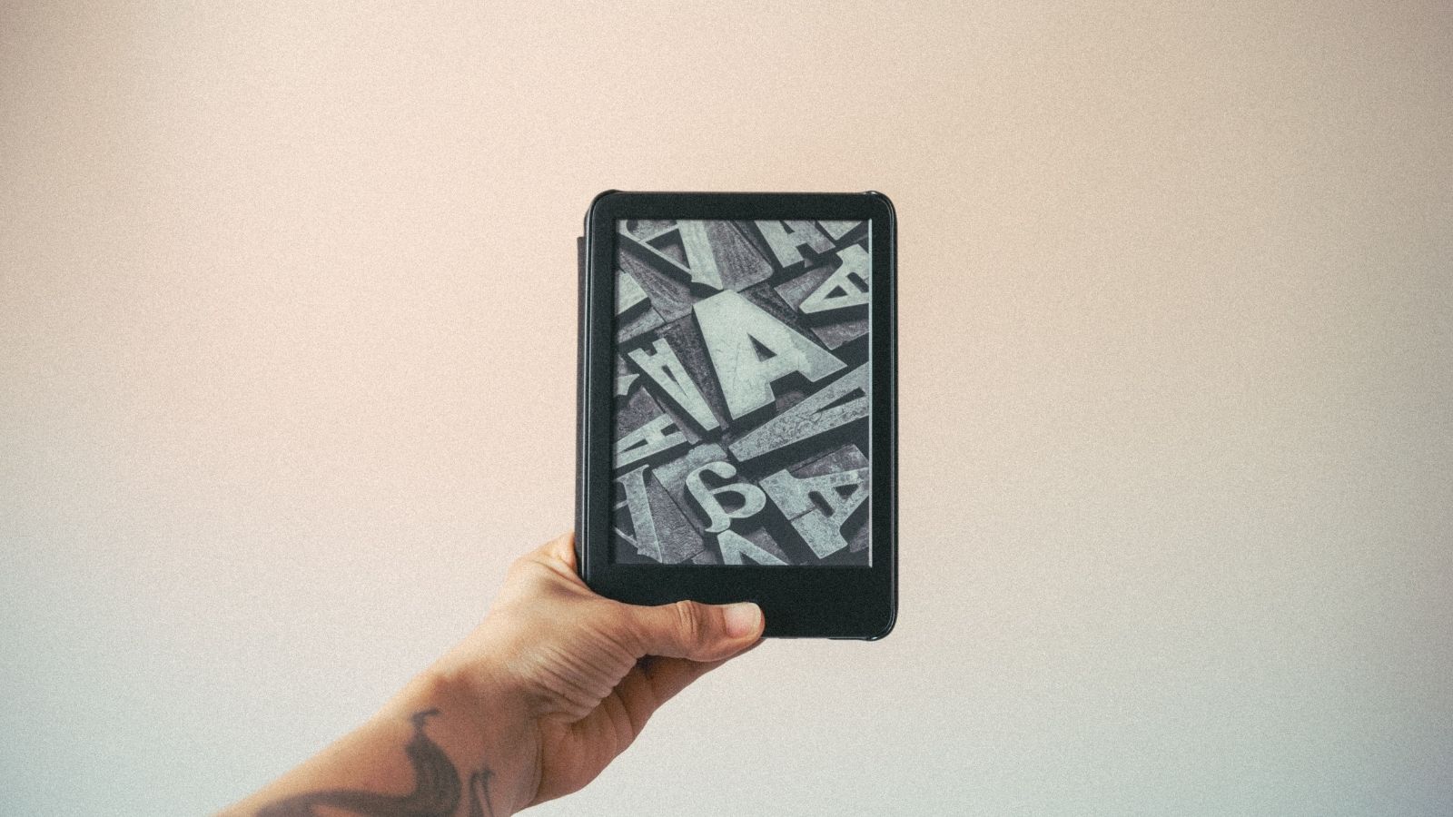 A person holding a Kindle
