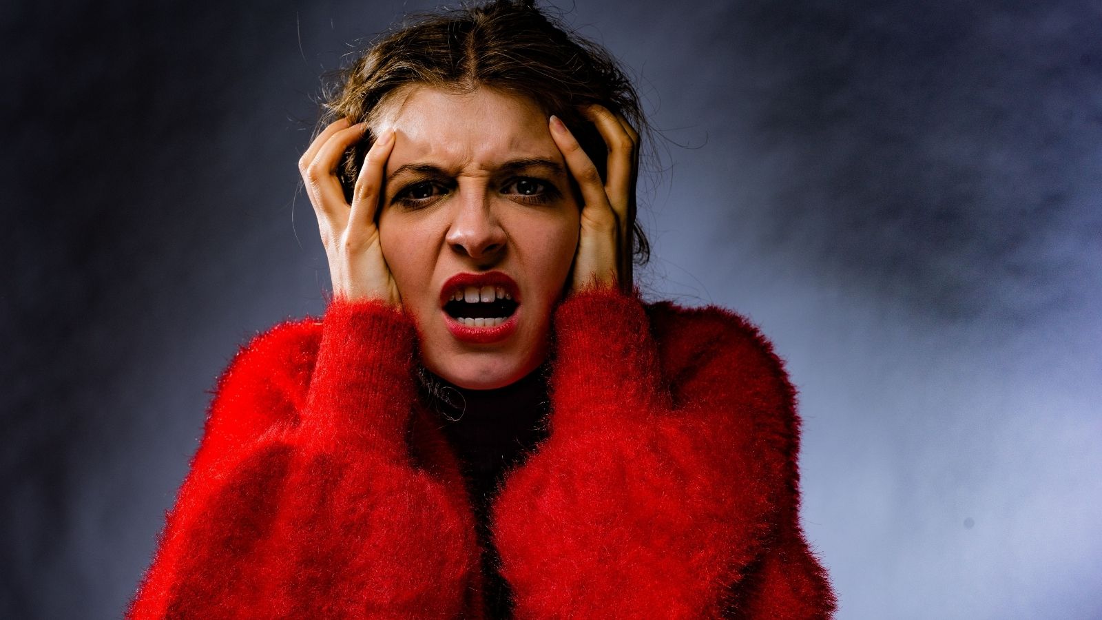 She Confronted Her Colleague for Being Toxic, And By the End of the Conversation, Shed Stooped to His Level An angry woman in a red jumper