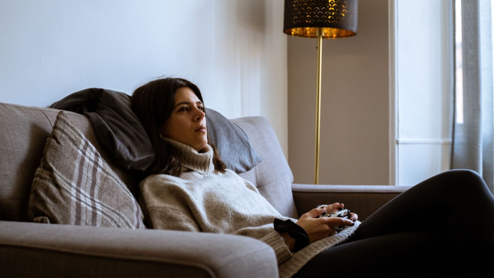 He Didn’t Mind His Roommate’s Girlfriend Visiting, But Then She Started Interfering With His Work Life A woman playing video games on the couch