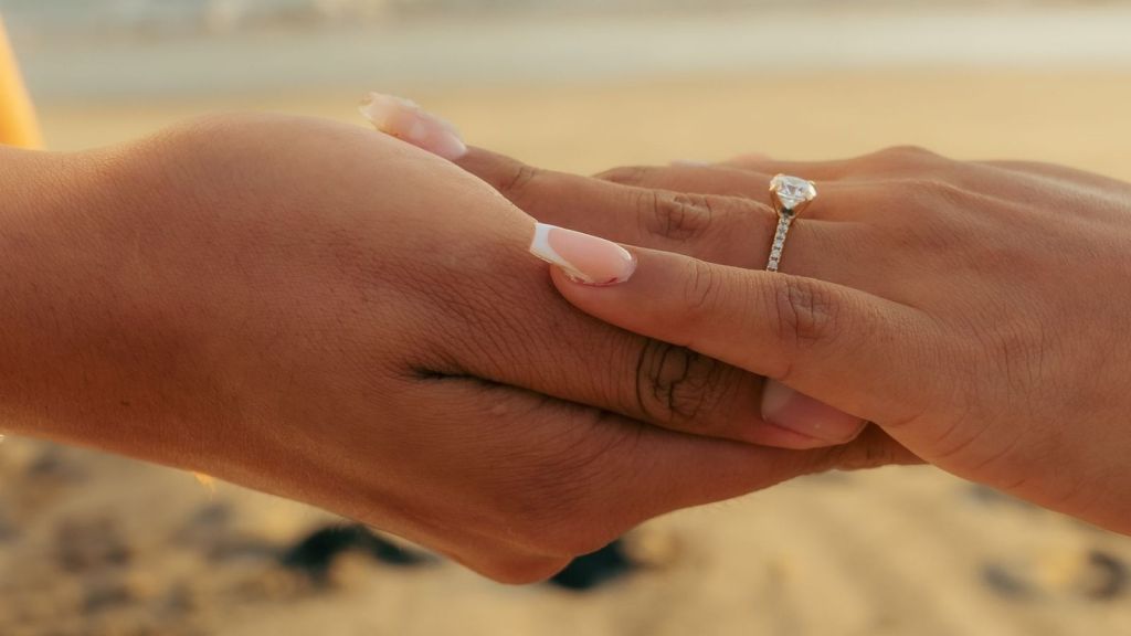 Holding hands with an engagement ring on