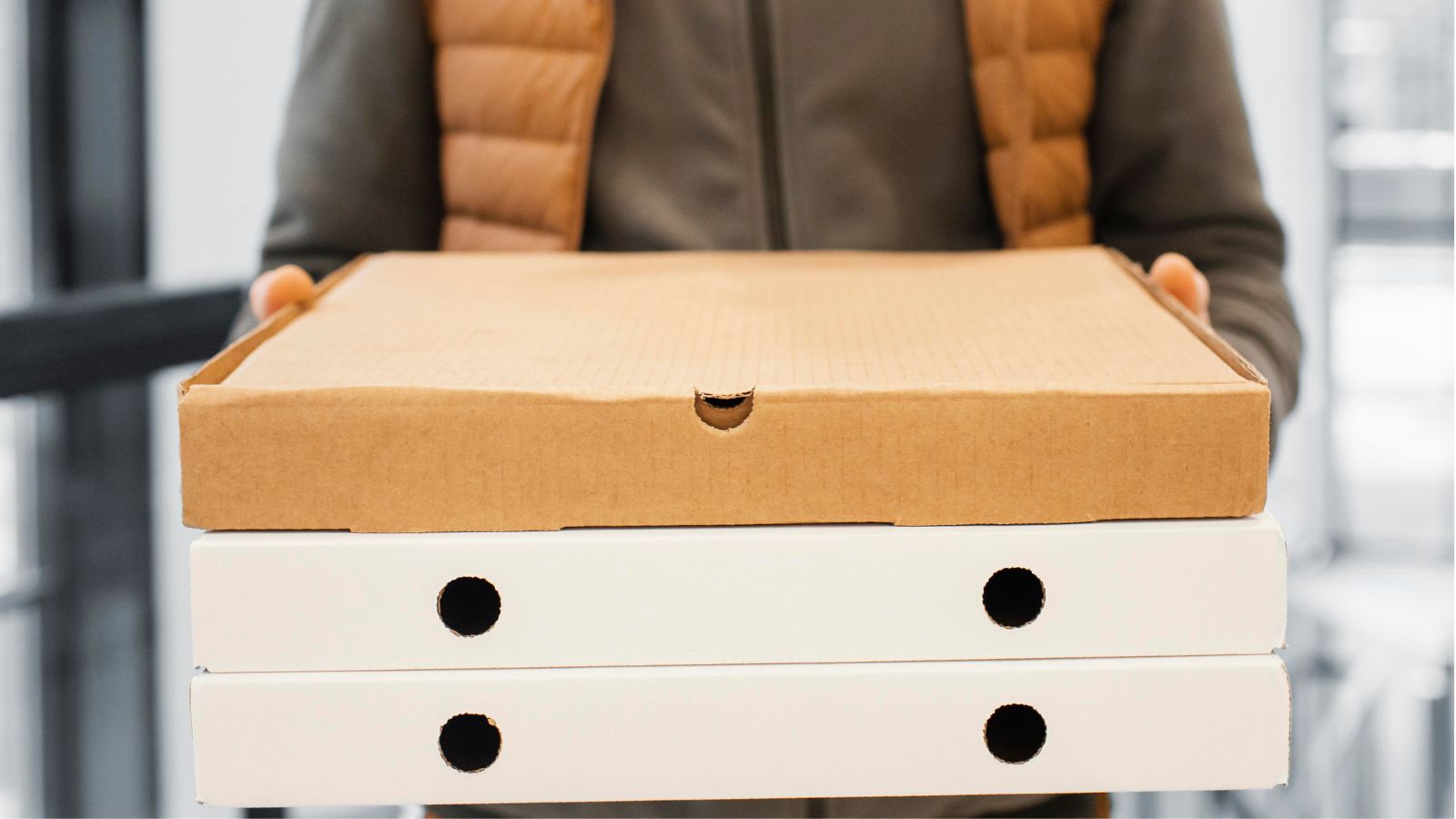 Guest Food Orders Keep Going to the Wrong Hotel — and Nobody Will Fix the Address in the App Delivery man holding three boxes of pizza