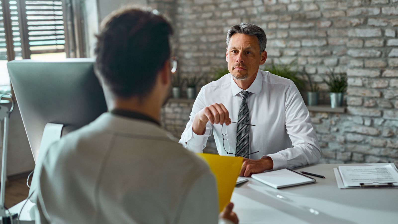 The Beach Ban: How a Bizarre Personal Life Restriction Turned One Mans Final Job Interview Into a Massive Red Flag Employee interviewing a job candidate in the office