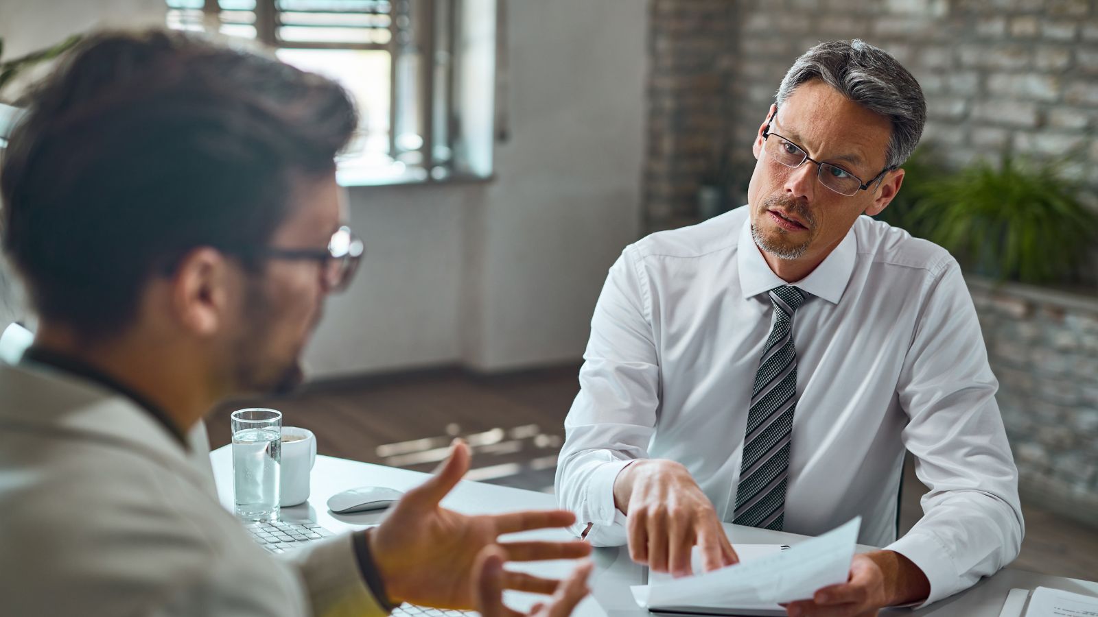 He Never Got His Annual Raise—And No One at Work Could Agree on the Reason Employee talking to his boss in the office
