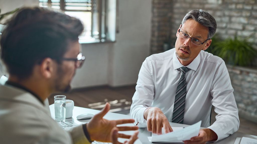Employee talking to his boss in the office