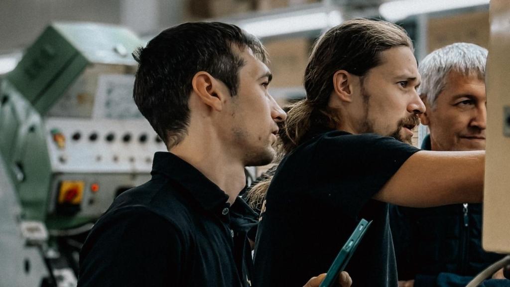 IT employees looking at back of computer