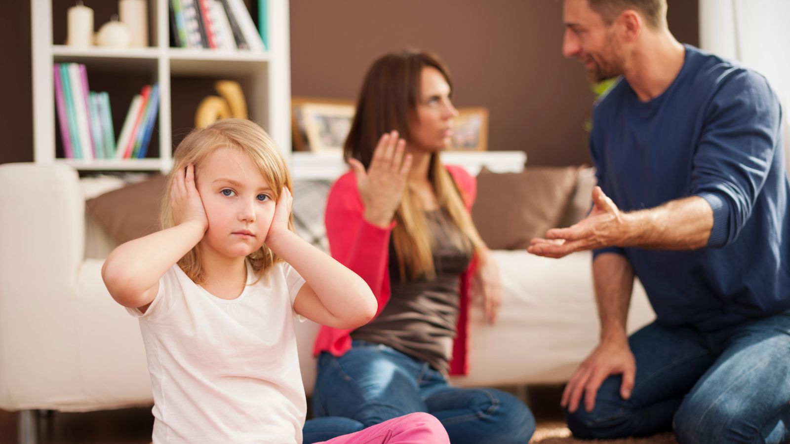 She Was Only 9 When She Learned Her Dad Was Cheating—Years Later, Her Mom Turned to Her for Answers Man and woman fughting while a little girl feels uncomfortable