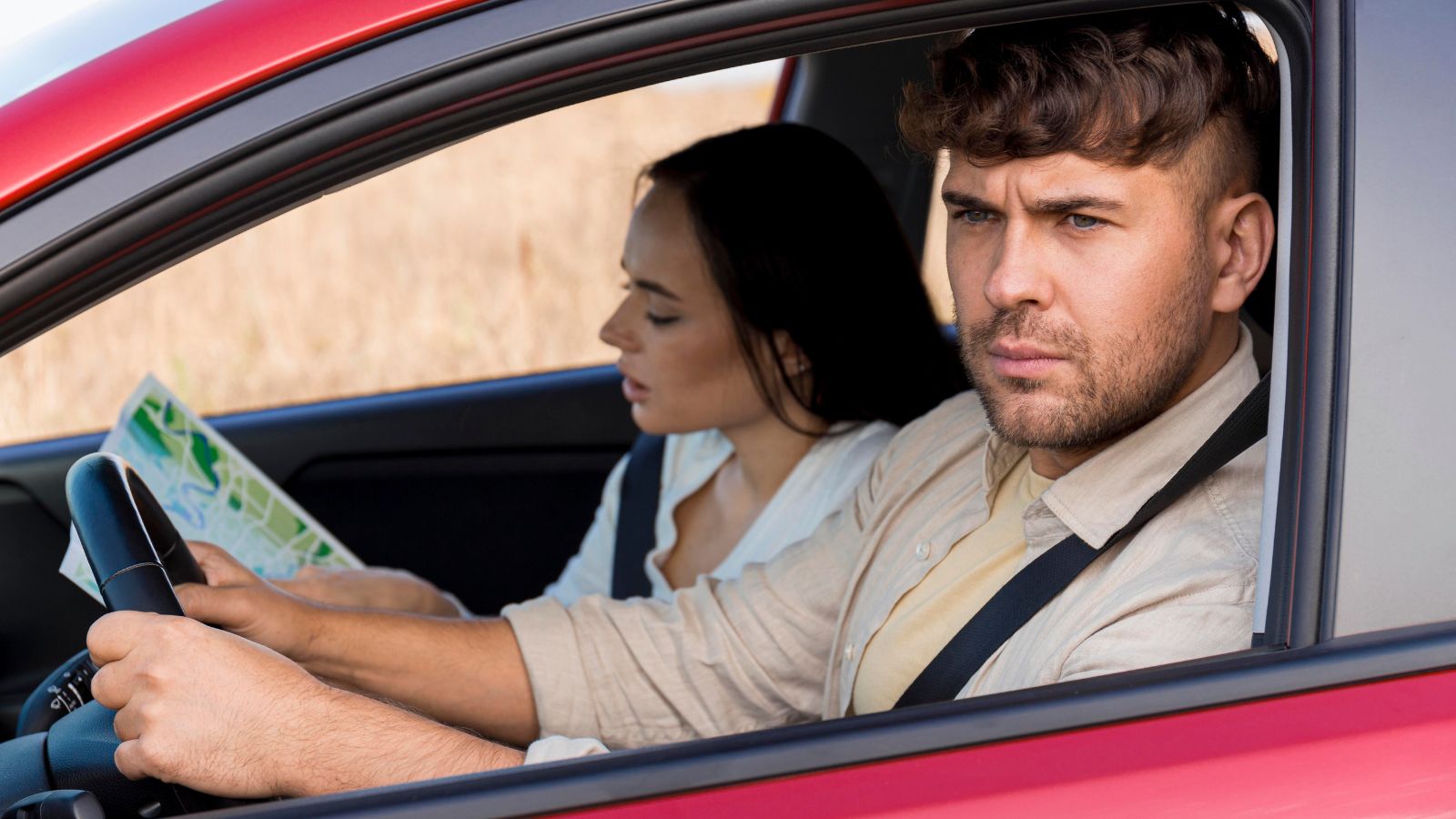 She Asked Her Boyfriend to Look Something Up — He Read Her an AI Response — She Told Him to Stop Using AI Entirely Man frowning and driving a car with a woman looking at a map