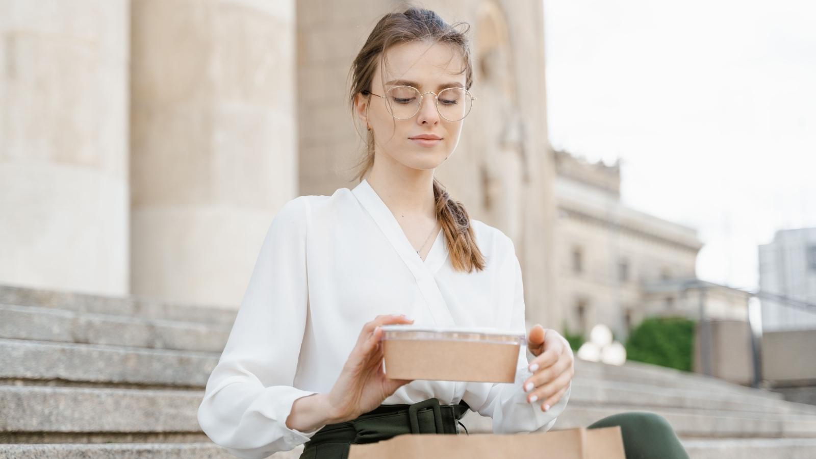 Woman looking at her takeout food