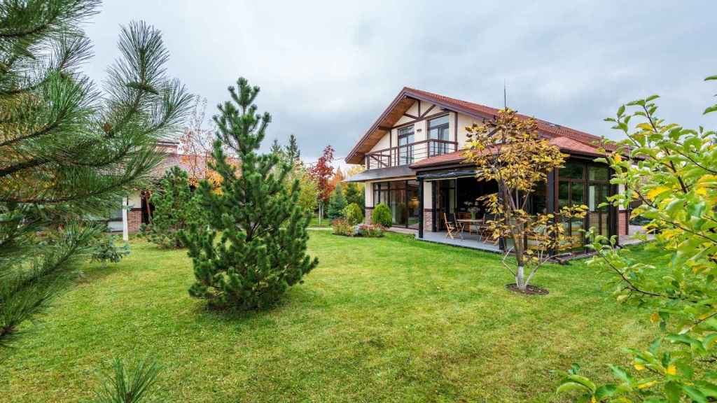 Nice house with a small tree in the backyard