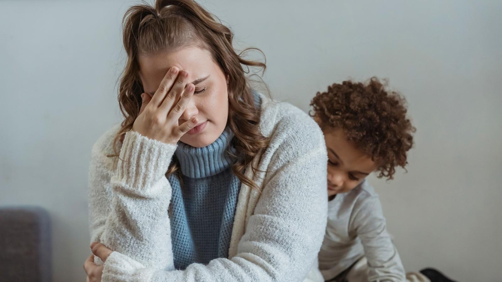 An Innocent Family Is Reeling After a Downstairs Neighbor Hired a Lawyer Over Toddler Footsteps Stressed mom sitting by her son