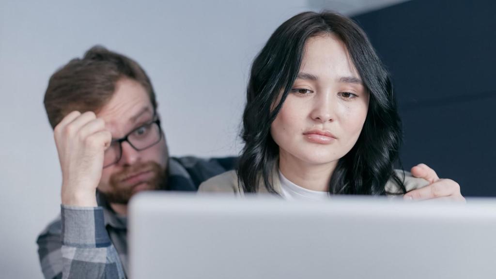 Woman and man looking at an account online