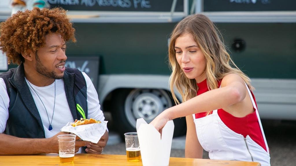 Woman stealing her boyfriend's french fries