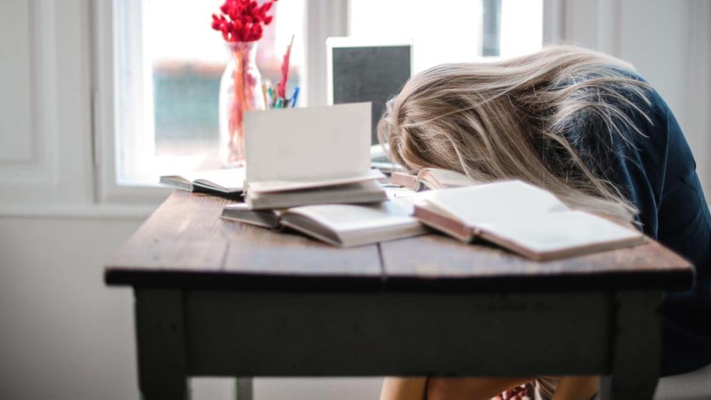 Woman stressed with her head on her desk