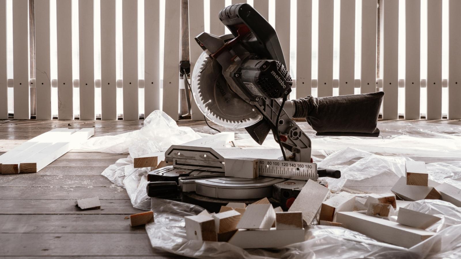 He Destroyed a Borrowed Miter Saw and Bought a Replacement—But One Question Still Remains Miter saw sitting on the ground around scraps