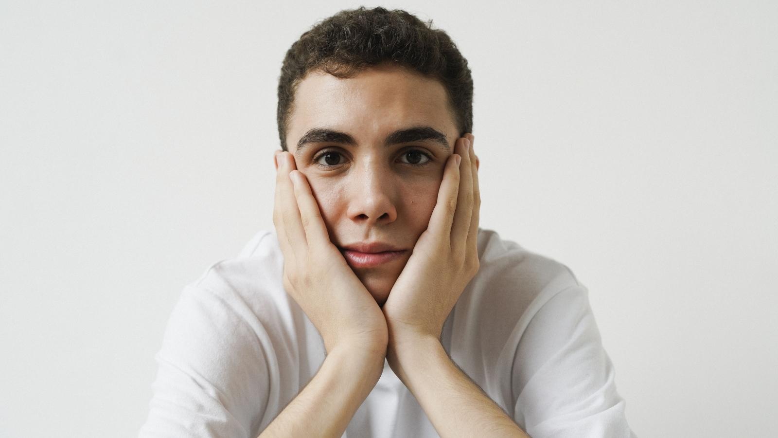 He Moved Away With His Girlfriend to Build Their Own Life — Her Family Has Turned Their Tiny Apartment Into a Second Home Young man thinking about problem with his GF