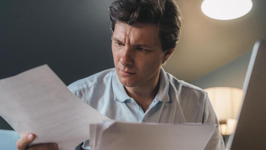 Man looking at new floor plans for his store