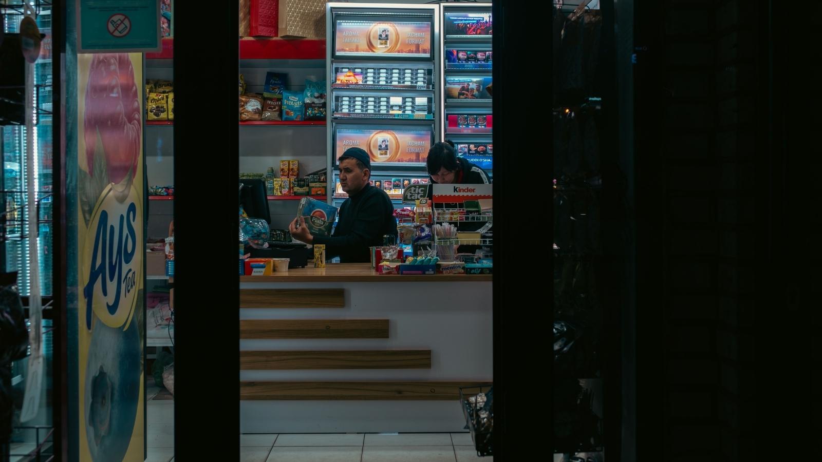 He Finally Got the Cashier to Process His Purchase—Then One Mistake Made the Employee Walk Away Convenience store workers sitting behind the counter