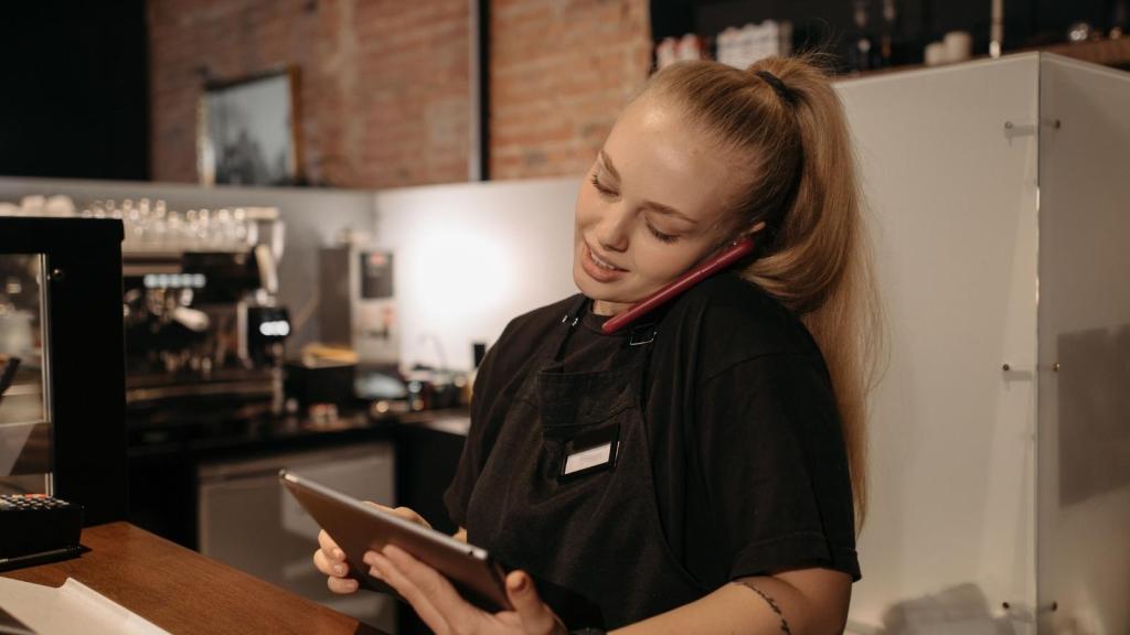 Woman working at a restaurant on the phone