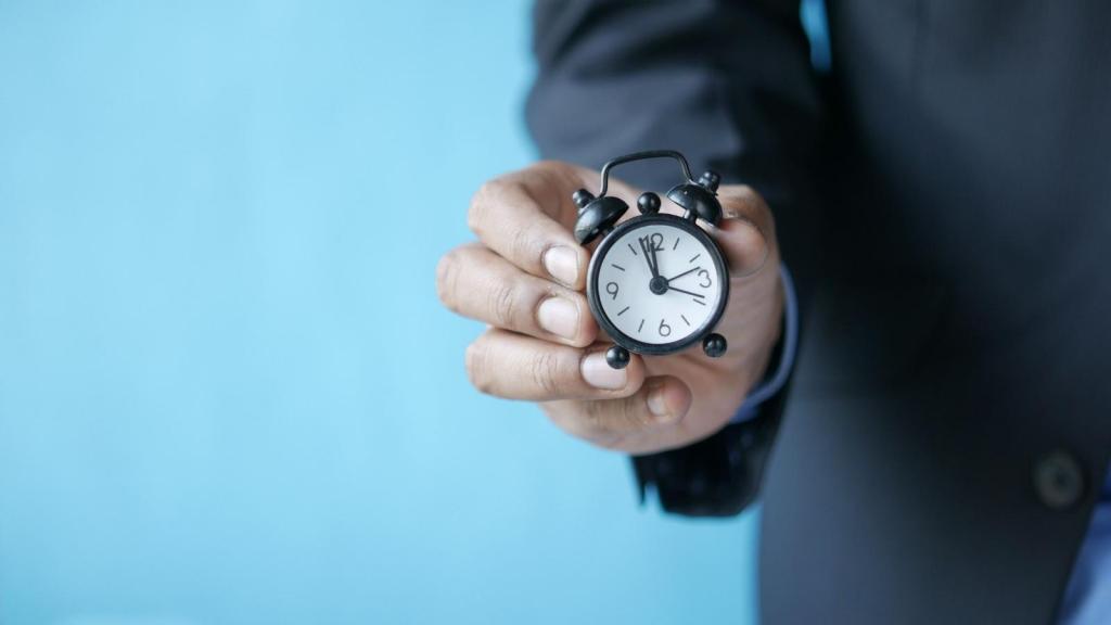 Manager holding a small time clock for tracking