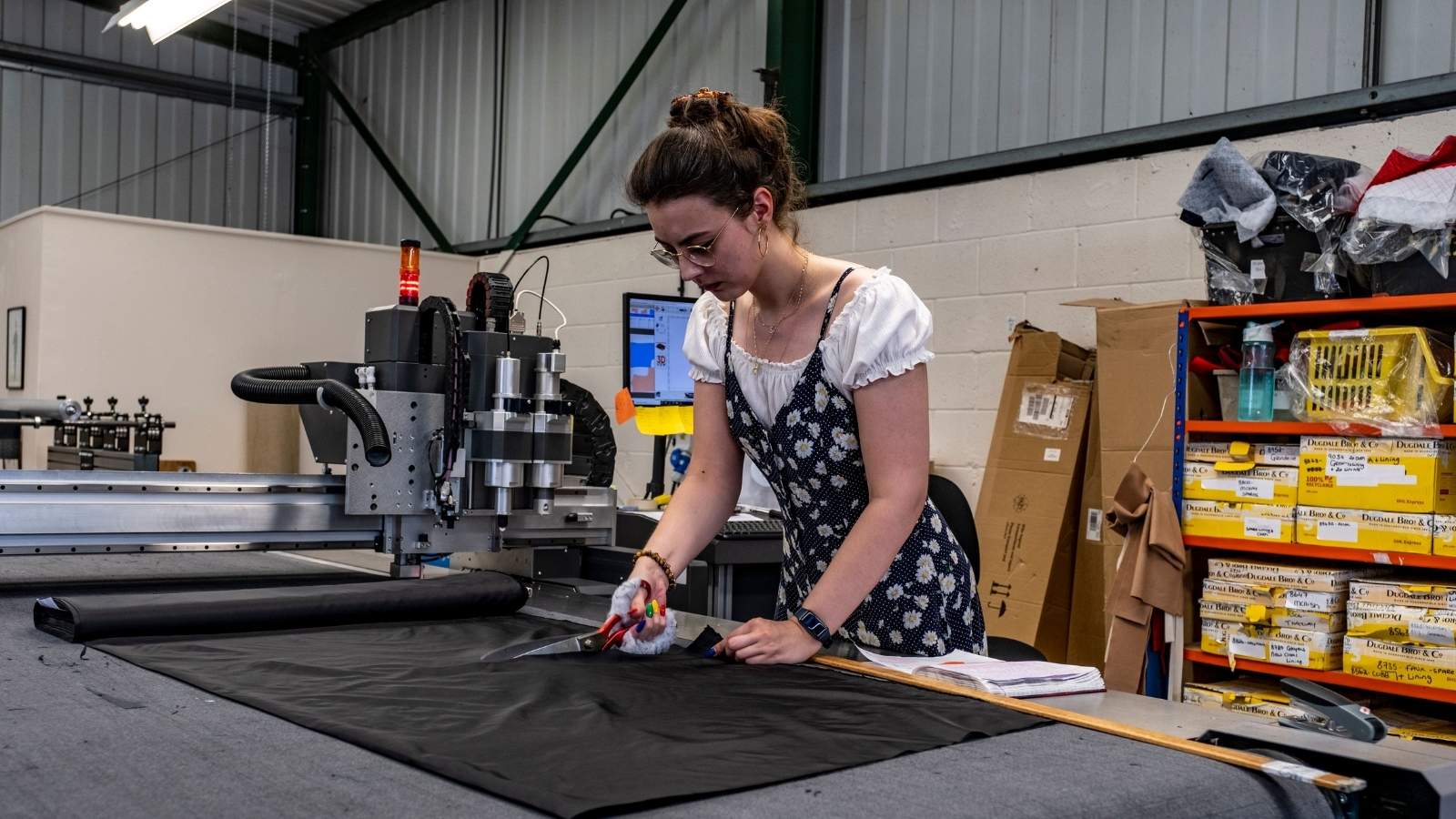 A Retail Worker Stepped In to Help a Fabric Customer. Then She Caught the Woman Trying to Sneak Out Free Product. Woman cutting a bolt of fabric