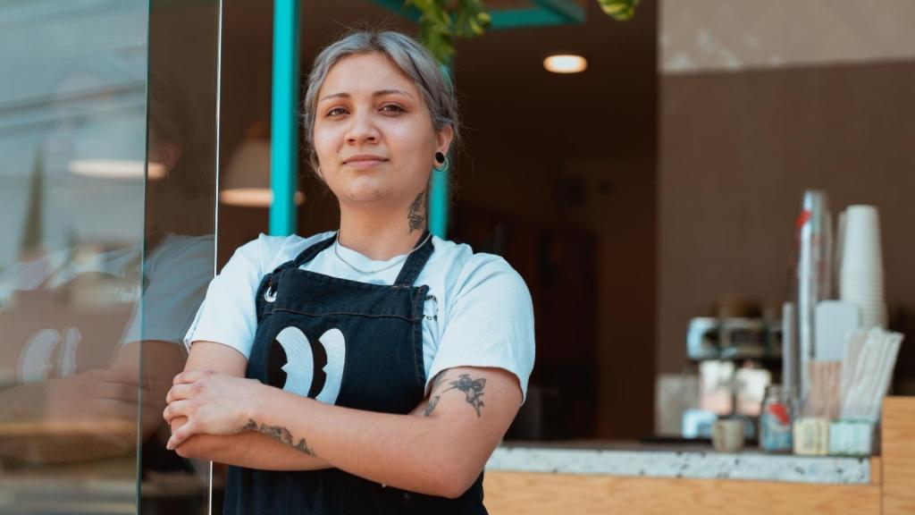 Waitress leaning up against the front door