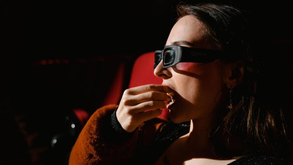 Woman eating popcorn at the movies