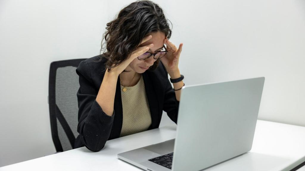 Woman stressed at her computer during work