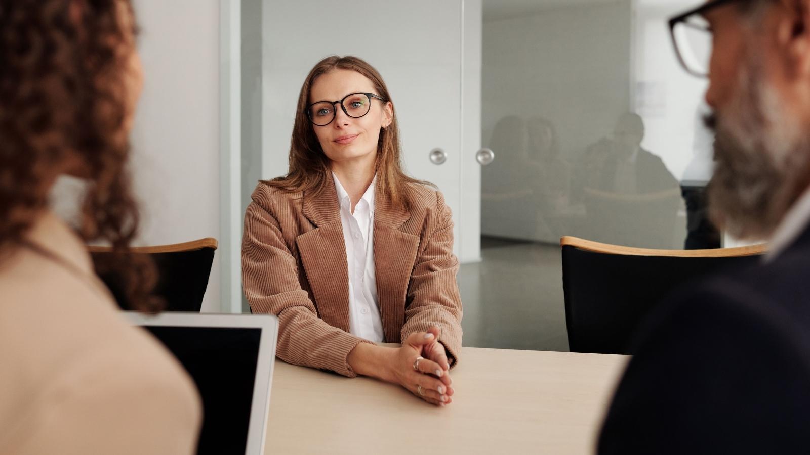 An Office Manager Reported a Bully to HR. They Excused the Abuse Because the Coworker Was Pregnant—Then Fired the Manager 48 Hours Later. Woman in a meeting with HR