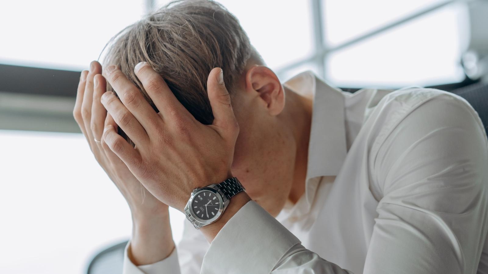 Man holding his face, stressed out. 