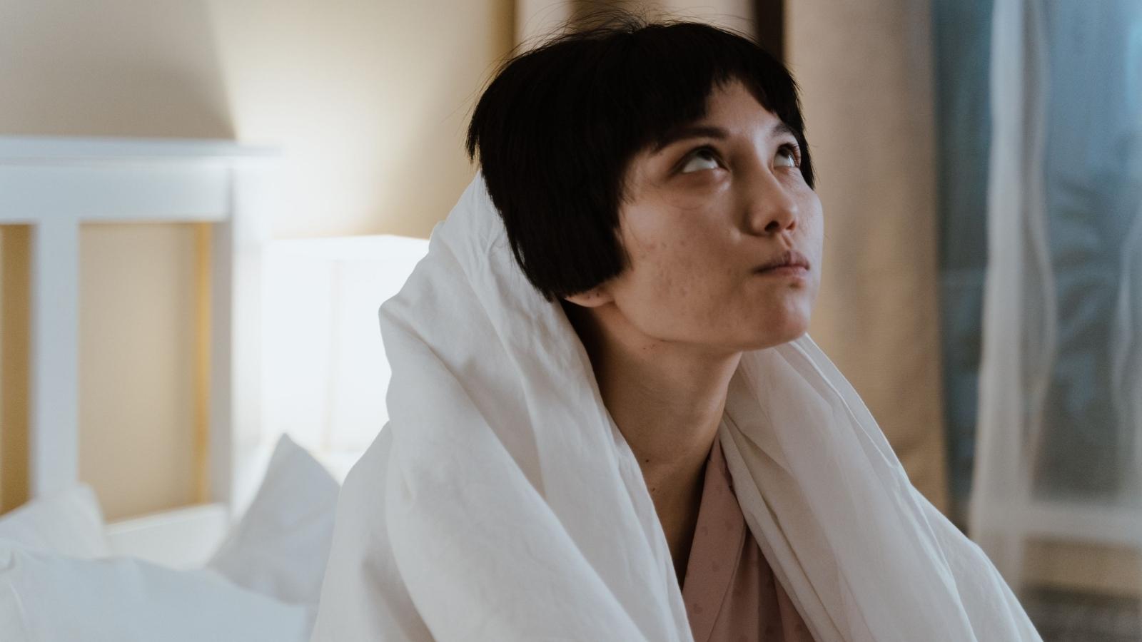 Woman looking up at the ceiling because her neighbor is yelling again