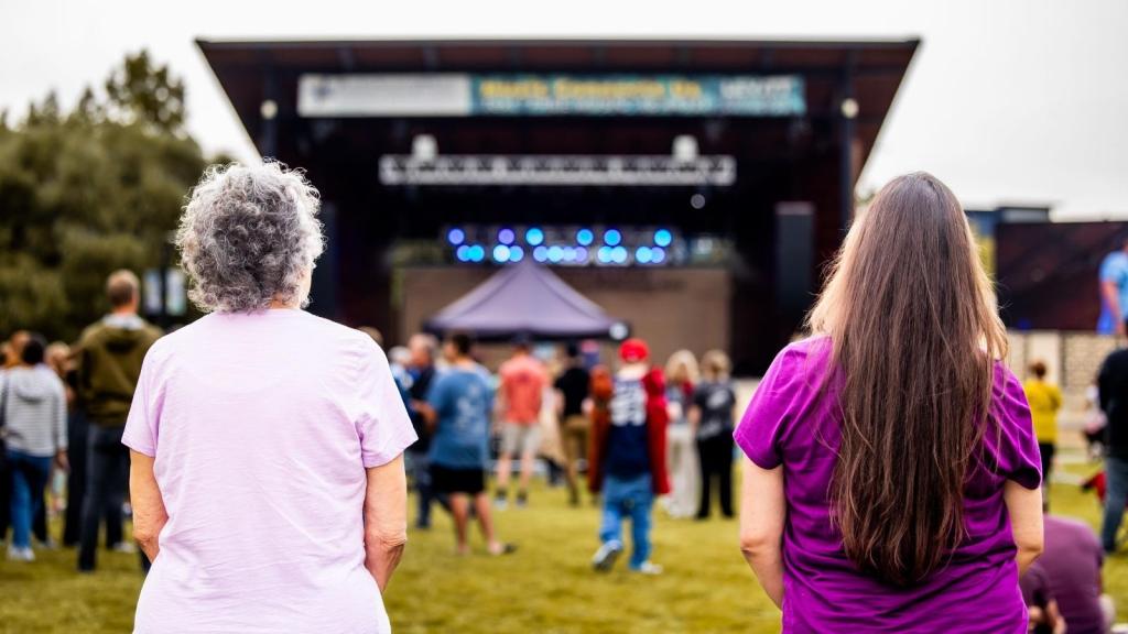Woman watching a band at a church festival