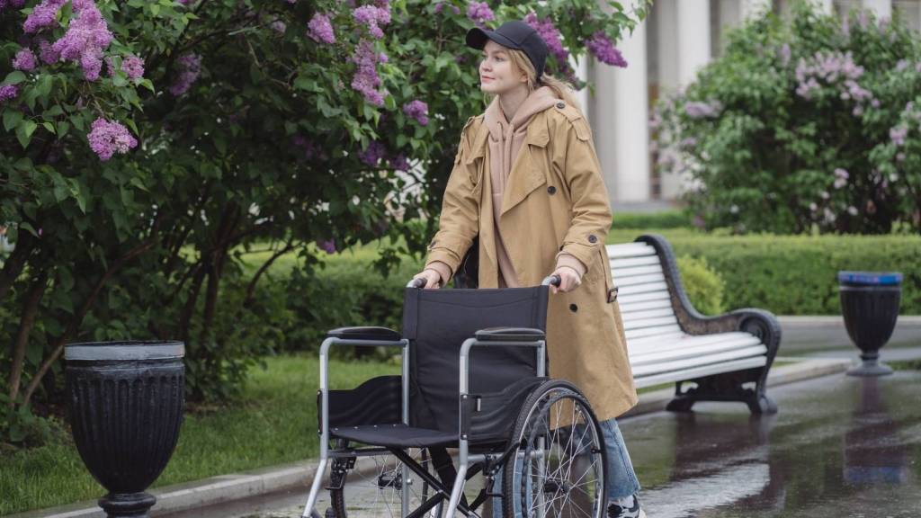 Woman pushing a wheelchair for her mother