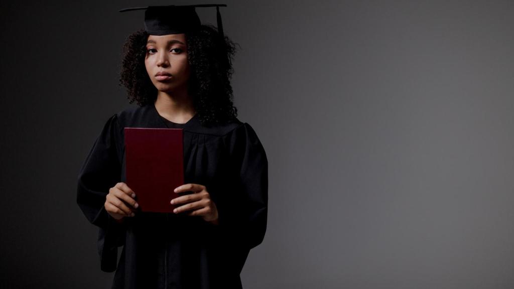 Sad woman holding a graduation diploma