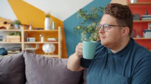 Man sipping coffee, thinking about his mean MIL