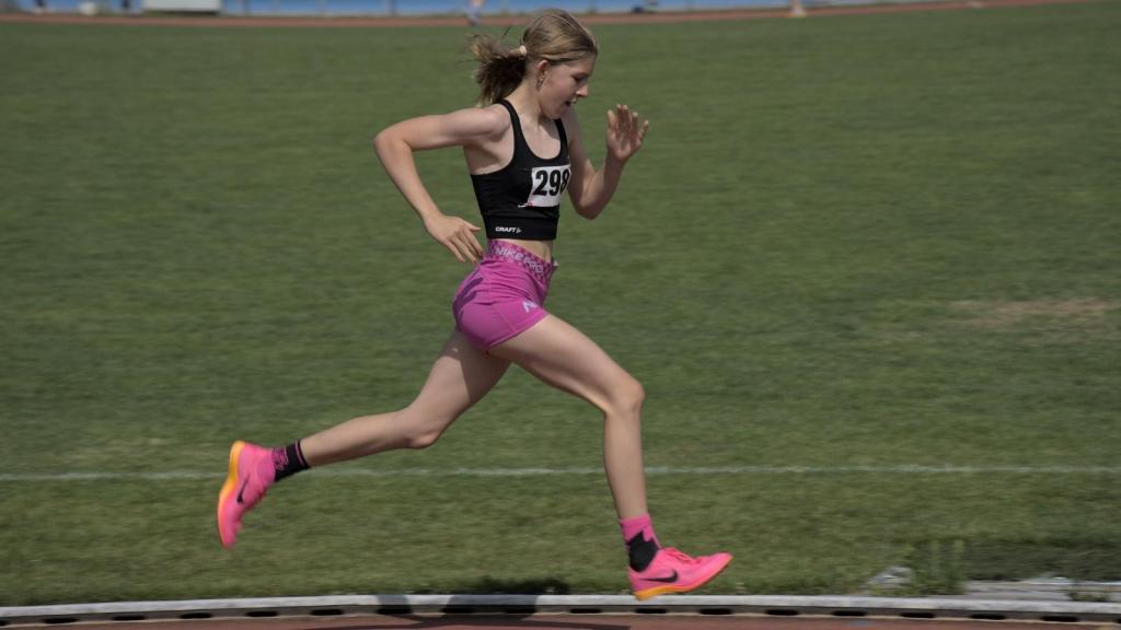 Young girl running cross-country