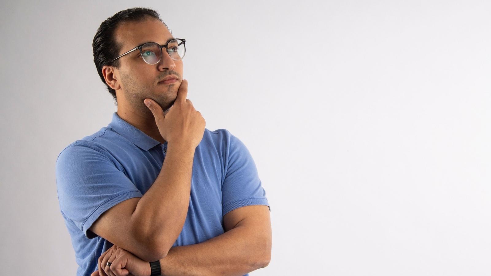I Dont Work Here!: Shopper Forced into Standoff as Persistent Customer Demands Hel Man in blue shirt thinking about interaction