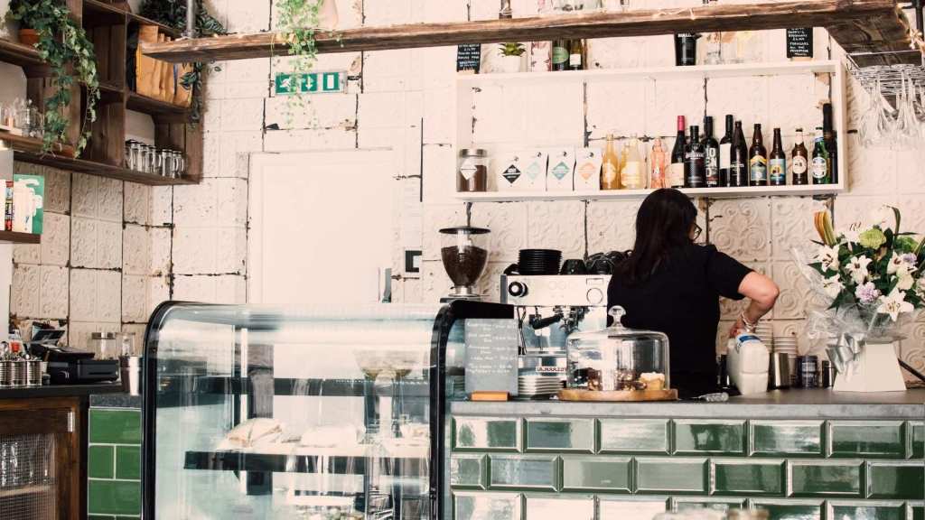 Woman working alone in a busy cafe