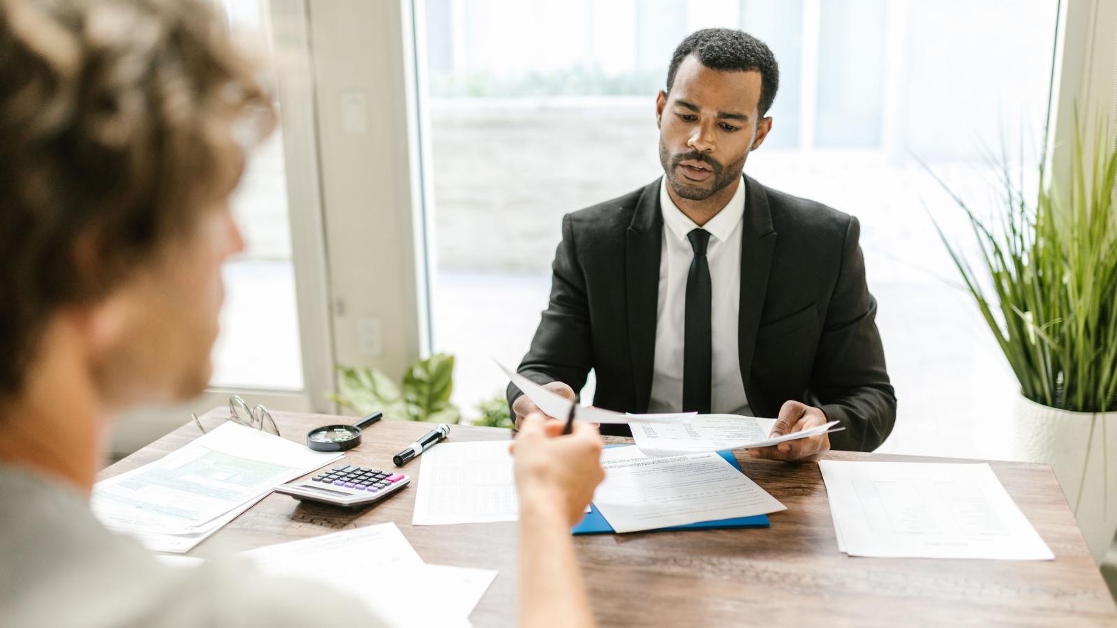 Man sitting at his desk talking to his new manager