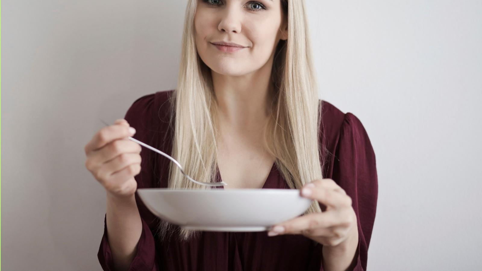 She Thought She Was Looking Out for Her Friends, But They Felt Her Meal Comments Went Too Far woman eating out of a bowl
